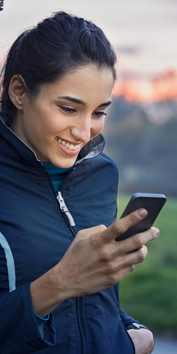 Woman holding a smartphone and smiling