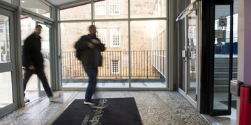 Student entering Merchiston campus through doorway