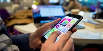 Student looking through the Edinburgh Napier app on their mobile phone